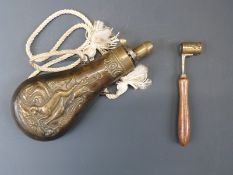 Brass powder flask with embossed decoration of dogs and birds and rope hangar (20cm long) together
