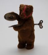 Vintage mohair covered clockwork dancing bear playing the cymbals, 13cm tall