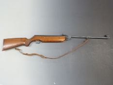 Weihrauch HW35 .22 air rifle with chequered semi-pistol grip and leather sling alignment sights,
