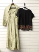 Green brocade dress and black shirt with embroidered hem