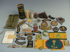 A small collection of militaria including Women's Land Army (WLA) cloth arm bands, cloth insignia,
