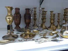 A large quantity of brass and copperware including many pairs of ejector candlesticks