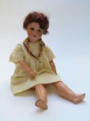 Armand Marseille bisque headed doll with open mouth, weighted brown eyes, brown hair, articulated