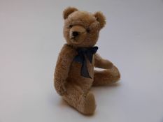 English Teddy bear, possibly Farnell or Steiff, with blonde mohair, shaved snout, glass eyes,