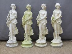 A set of four garden statues of ladies with flowers, height 65cm