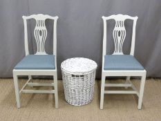 Two white painted chairs and a similar linen basket