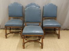 Set of four upholstered chairs with curved moulded stretchers