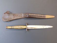 A Fairburn/Sykes style fighting knife with brass handle, blade length 16cm with leather sheaf