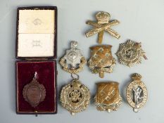 Military badges including The Royal Sussex Regiment, Royal Signal Corps, Canadian Army Service Corp,