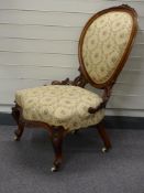 A 19thC mahogany upholstered nursing chair