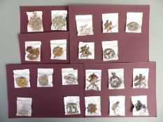 A collection of British Forces cap badges to include 19th Hussars, Tank Corps, School of Musketry,