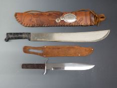A machete in decorated leather sheath. Blade length 46cm together with bowie knife in leather