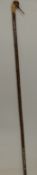 Carved and painted wooden walking stick with handle in the form of a woodcock, 145cm long.