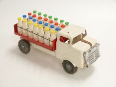 Tri-ang pressed steel milk float with cream body, red bed and plastic bottles