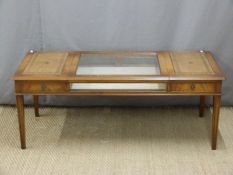 A reproduction leather inset bijouterie table, L124 x D56 x H47cm