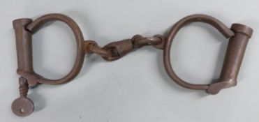 A pair of Hiatt wrought iron prisoners’ handcuffs