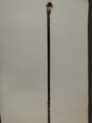 Mike Wood carved and painted wooden walking stick in the form of a spaniel, 150cm long.