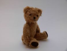Pedigree Teddy bear with golden mohair, brown felt pads, glass eyes, straw filled body jointed limbs