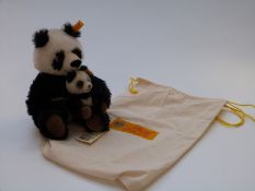 Two Steiff Teddy bears Panda Pair with black, white and brown mohair, 22cm tall, in original cloth
