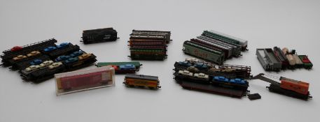 Thirty-seven Fleischmann, Lima and similar N gauge wagons, car transporters, cranes etc, one in