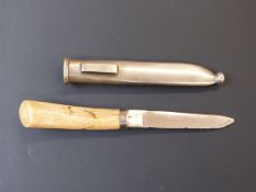 A late 19th/20thC ivory handled hunting or skinning knife in metal scabbard, the blade impressed C