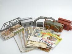 A large collection of 00 gauge buildings and accessories, some in kit form and some already built