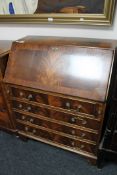 A mahogany Regency style writing bureau on bracket feet