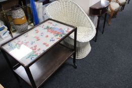 A mahogany glass topped two tier serving trolley together with a wicker chair and mahogany d-shaped