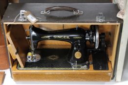 A cased mid twentieth century Singer hand sewing machine