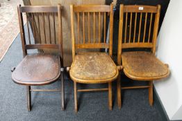 Three mid 20th century folding wooden chairs