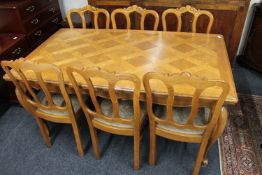 A French oak pull-out dining table on cabriole legs and six chairs