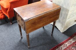 A Victorian mahogany drop leaf table fitted a cupboard