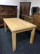 A contemporary dining table in an oak finish