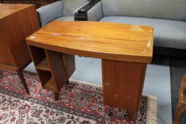 A mid 20th century teak knee hole desk