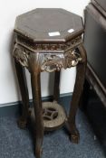 A carved octagonal eastern style plant pedestal