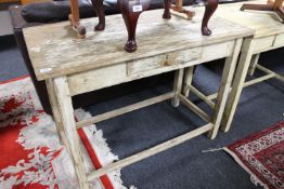 A distressed pine kitchen work table fitted a drawer