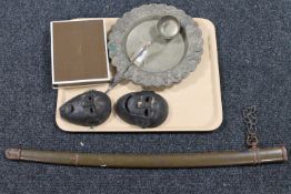 A tray of two carved hardwood wall masks, four Wako plated knife rests, sword scabbard,