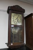 An oak cased wall clock