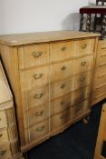 A blond oak shaped fronted five drawer chest with brass handles CONDITION REPORT: