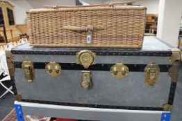 A mid 20th century metal trunk and a vintage picnic basket