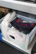 A crate of sealed bedding including sheets, quilt, pillow cases,