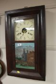 A late Victorian wall clock with glazed panel door