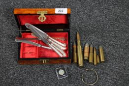 A trinket box containing a quantity of defunct ammunition, set of six silver handled knives, bangle,