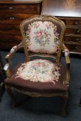 A carved walnut framed armchair upholstered in floral fabric