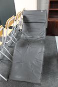A black faux leather lounger chair