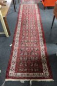 A fringed North-West Persian runner on red ground,