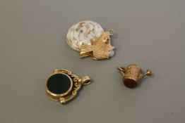 Three various gold fobs/charms