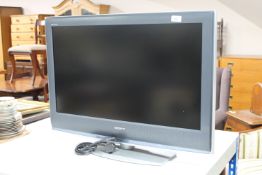 A Sony Bravia 32 inch LCD TV with lead and remote
