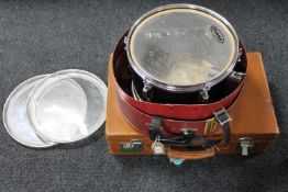 A vintage leather luggage case together with a drum case containing an Evans drum with skins