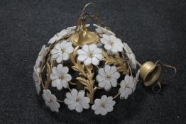 A contemporary brass light fitting with glass flower decoration
